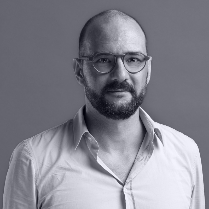 Portrait of Stefan Schlegel, Director of the SHRI. Mr Schlegel wears glasses and a white shirt. He has clear eyes and a dark beard.